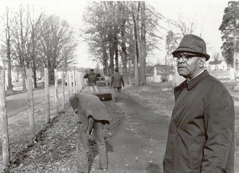 An image of Fred Alexander watching the fence come down.