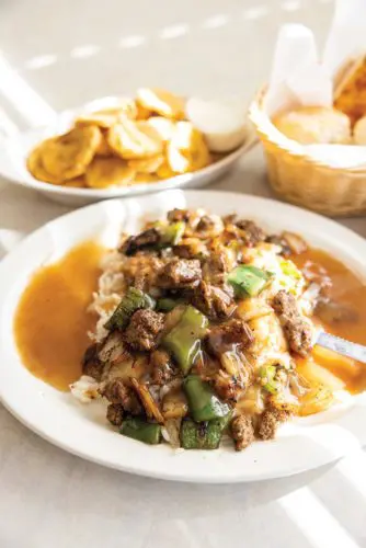 An image of beef tips and rice and their famous fried yellow squash.