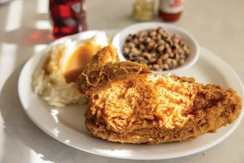 An image of fried chicken, black-eyed peas, and mashed potatoes.