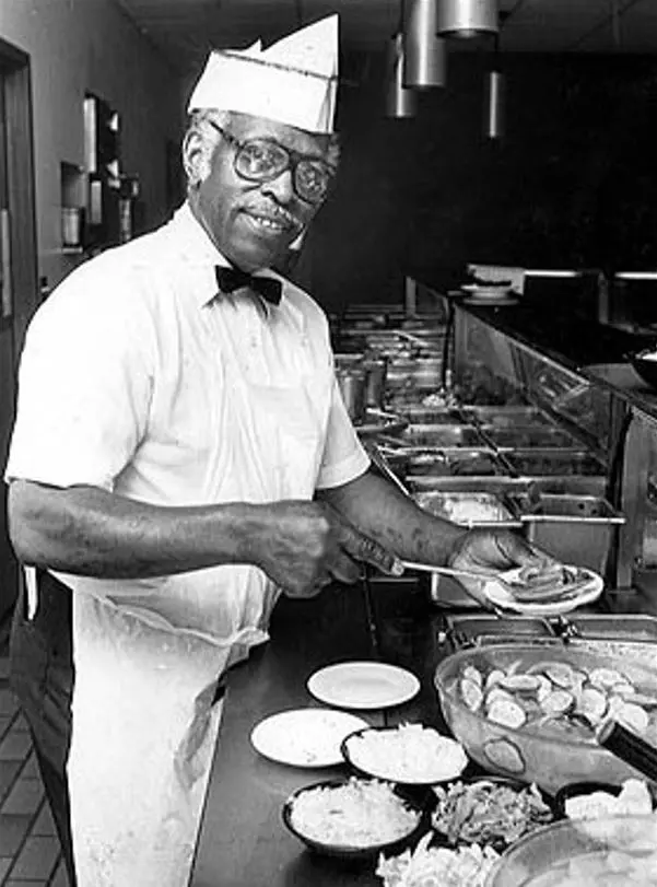 An image of John McDonald serving food.