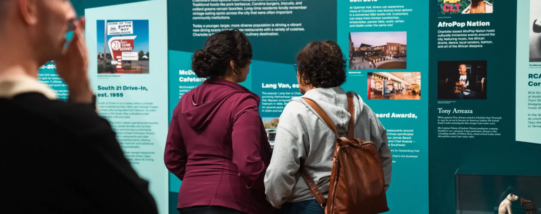 Visitors look at a Charlotte history exhibit