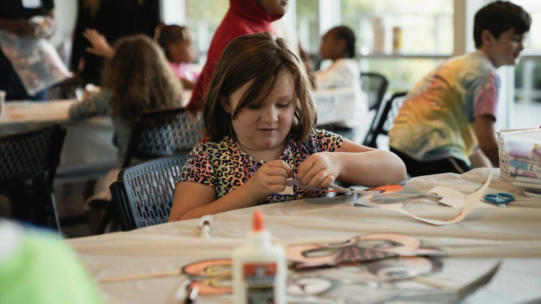 summer and day camps - little girl making a craft