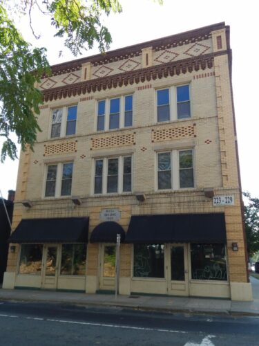 Photo of the front of the Mecklenburg Investment Company building on S. Brevard Street in 2019.