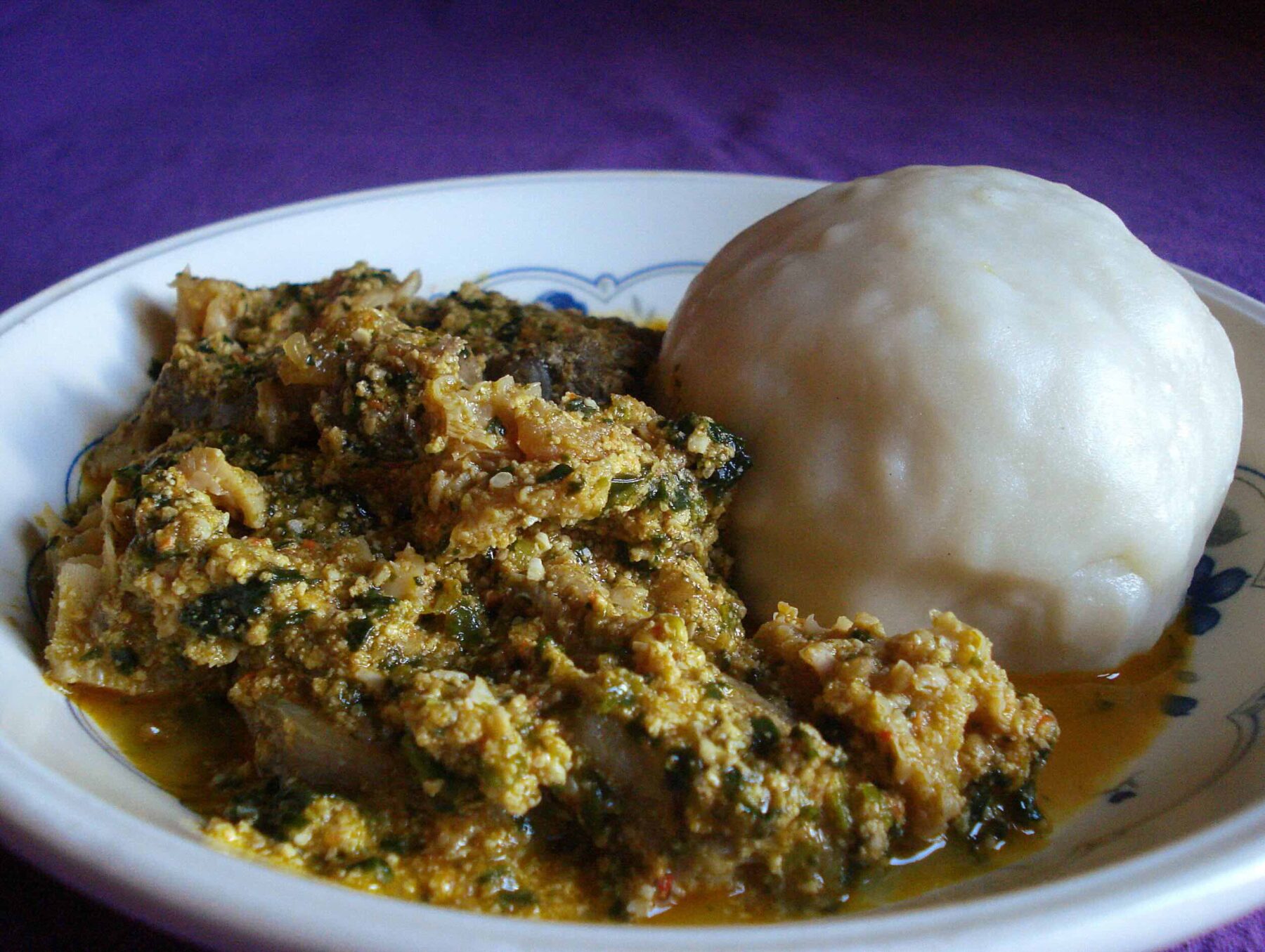 An image of egusi stew and pounded yam.