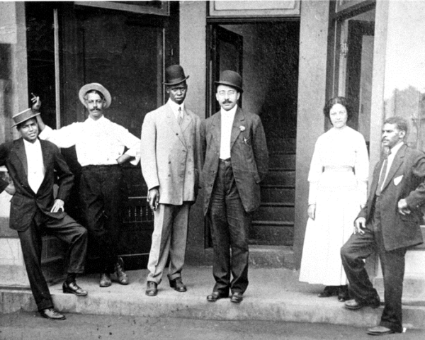 An image of businessmen standing in front of a building.